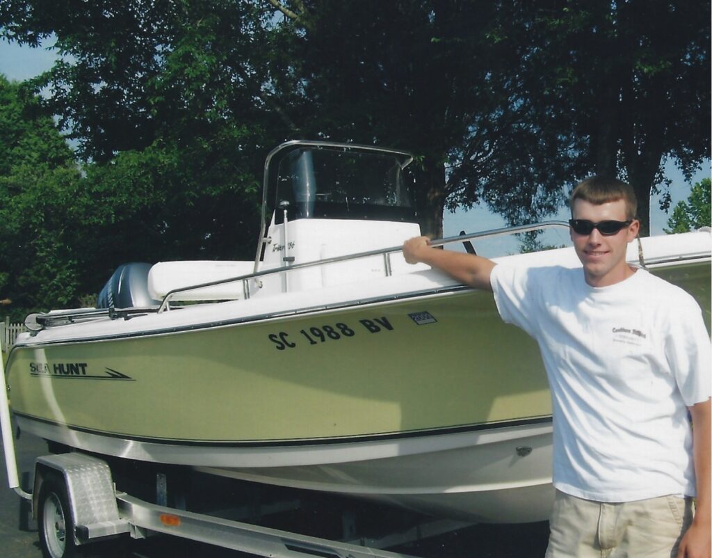 John Anthony Little poses with a boat.