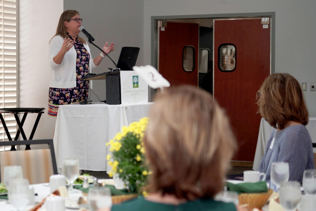 Amy Smith, executive director of The Women's Center, addresses the 2024 WGN Impact Luncheon as the keynote speaker.