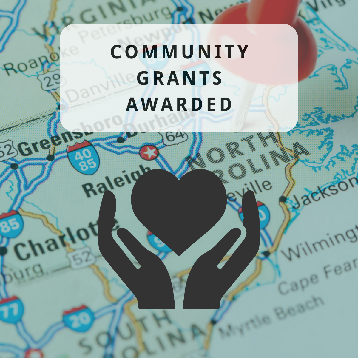 An image of a highway map showing part of North Carolina with text that reads "Community Grants Awarded" above a graphic of two hands holding a heart