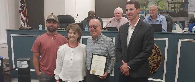 Jones was presented the award by Jones County Manager Kyle Smith (far right) and was joined at the ceremony by his son Matthew (far left) and his wife Taffy.