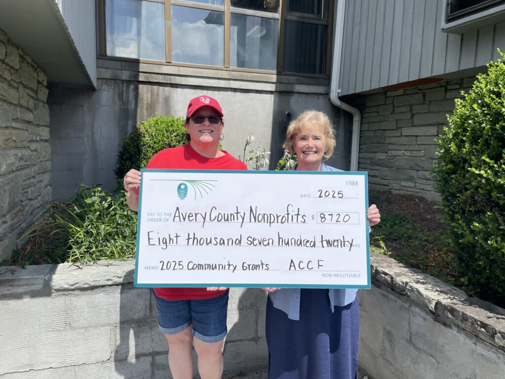 Avery Community Foundation grant committee members Gwen Clark (left) and Barbara Roesner (right) pose with a large check