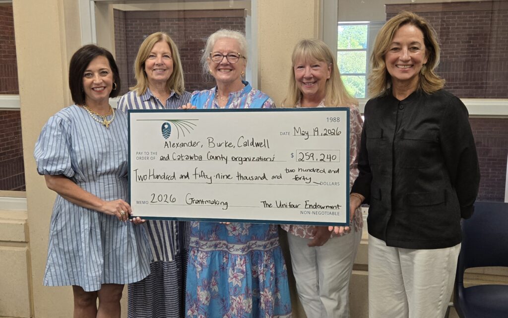 Unifour advisory committee members pose with large check